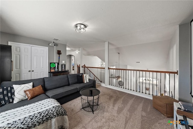 carpeted living area featuring visible vents and arched walkways