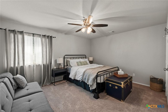 carpeted bedroom with visible vents and a ceiling fan