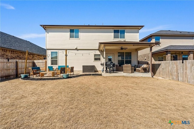 back of property featuring ceiling fan, a patio, a fenced backyard, and an outdoor living space