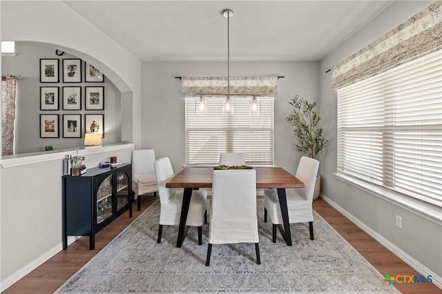 dining area featuring baseboards and wood finished floors