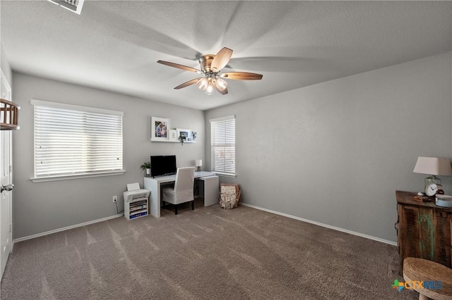 office space featuring a ceiling fan, a textured ceiling, baseboards, and carpet flooring