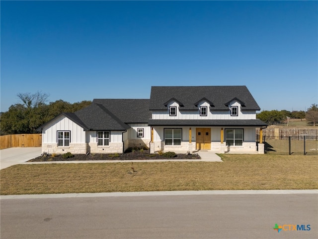 view of front of home featuring a front yard and a porch