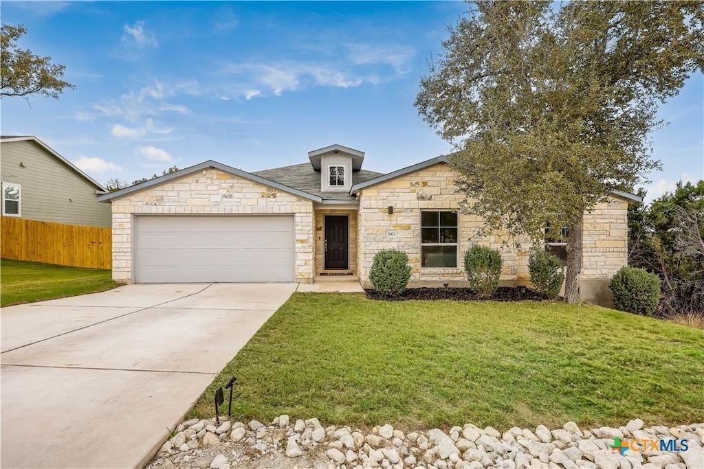 view of front facade with a garage and a front lawn