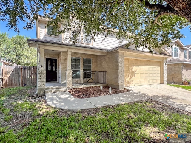 view of front of property featuring a garage and a porch