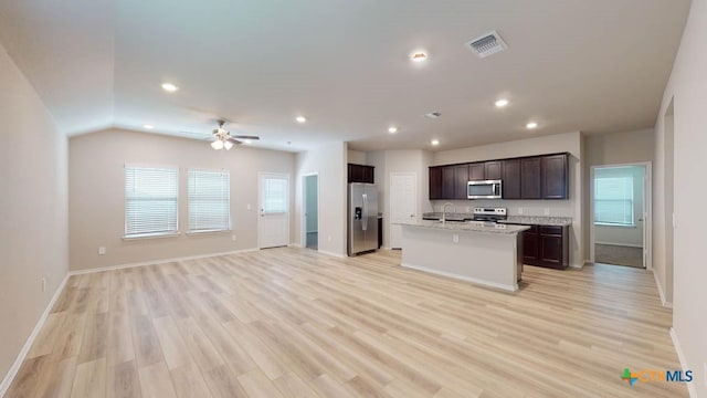 kitchen with a center island with sink, sink, light hardwood / wood-style flooring, ceiling fan, and stainless steel appliances