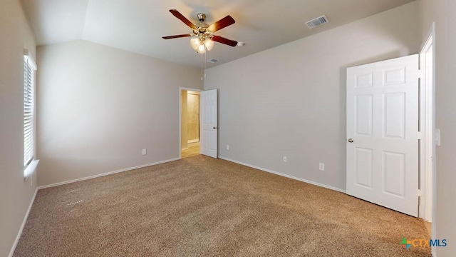 unfurnished bedroom with carpet flooring, lofted ceiling, and multiple windows