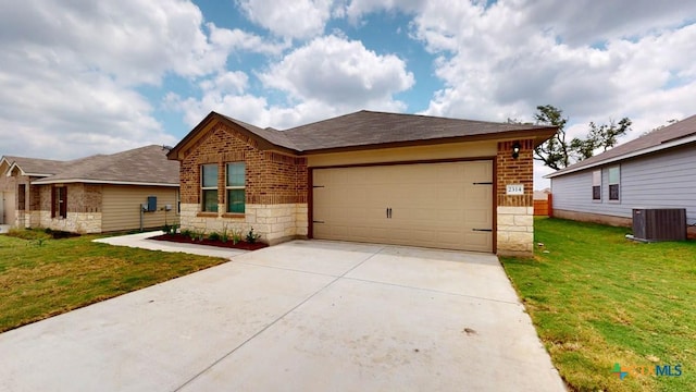 view of front of house with a garage, a front yard, and central AC