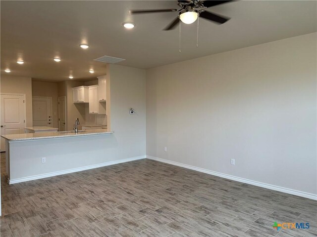 5100 Rose Petal Ct, Killeen, TX 76542 - unfurnished living room with wood finished floors, ceiling fan, and recessed lighting