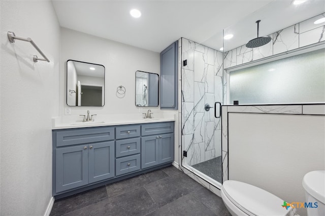 bathroom featuring toilet, an enclosed shower, and vanity