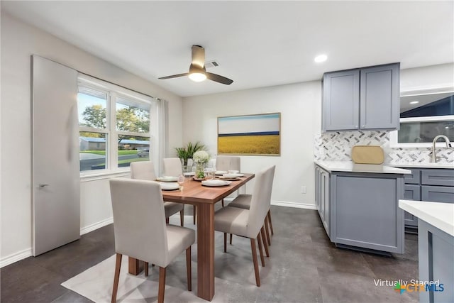 dining area with ceiling fan and sink