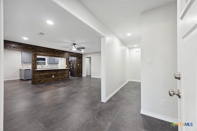 unfurnished living room featuring ceiling fan