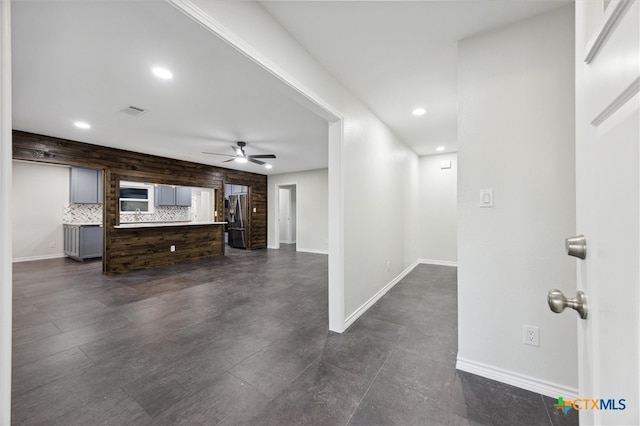 unfurnished living room with ceiling fan