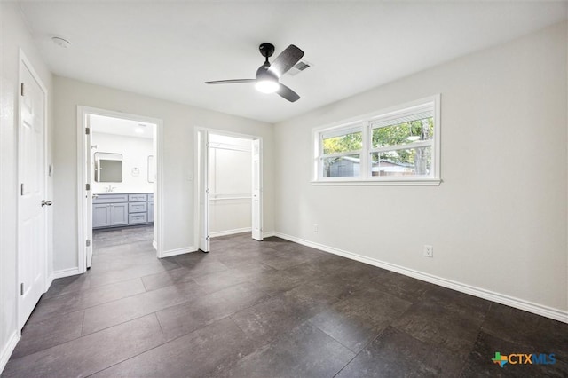 unfurnished bedroom featuring ceiling fan, a closet, and ensuite bathroom