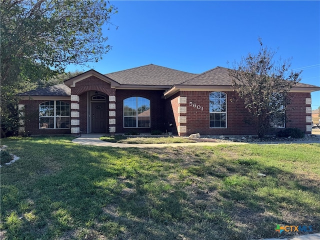 ranch-style home with a front lawn