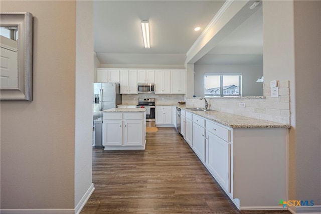 7624 Copper Creek Trl, Temple, TX 76502 - kitchen with appliances with stainless steel finishes, a sink, decorative backsplash, white cabinetry, and dark wood-type flooring