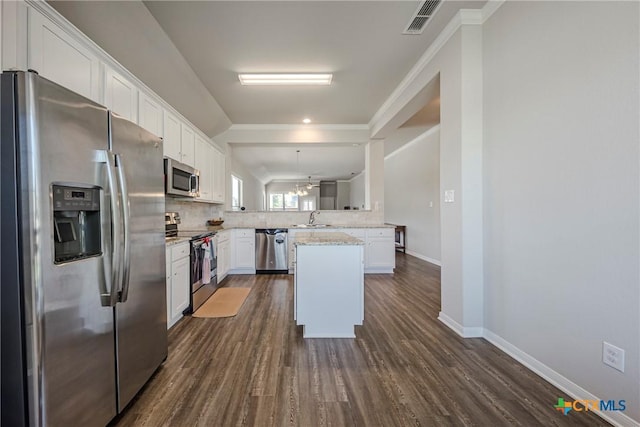7624 Copper Creek Trl, Temple, TX 76502 - kitchen featuring appliances with stainless steel finishes, a sink, white cabinetry, dark wood-style floors, and ornamental molding