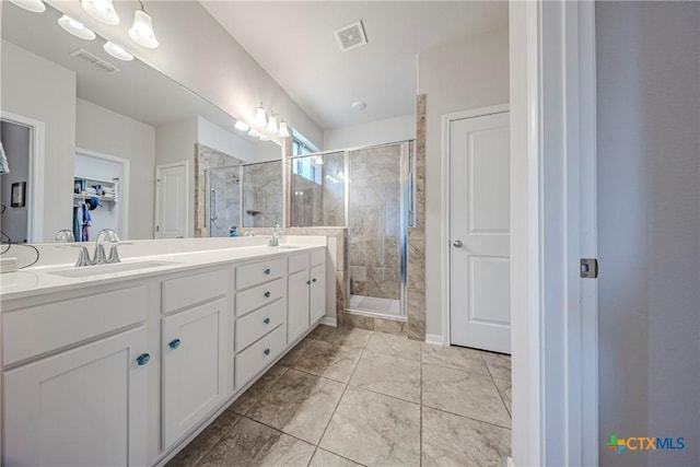 7624 Copper Creek Trl, Temple, TX 76502 - bathroom featuring double vanity, a stall shower, and a walk in closet