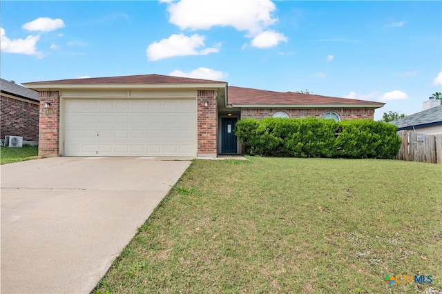 single story home featuring a garage and a front yard