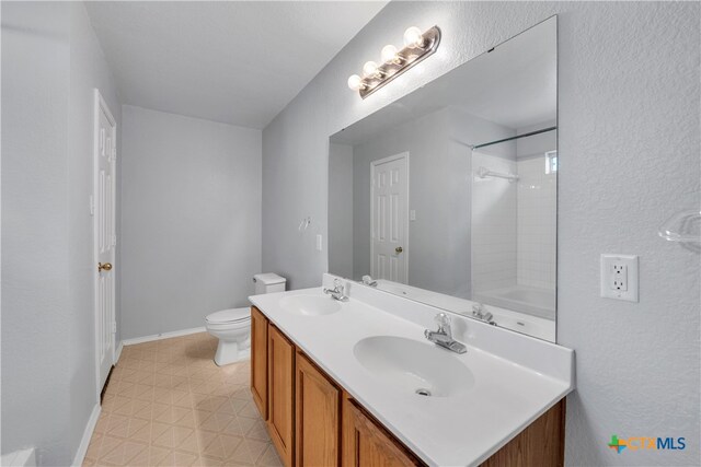 full bathroom featuring vanity, toilet, and tiled shower / bath