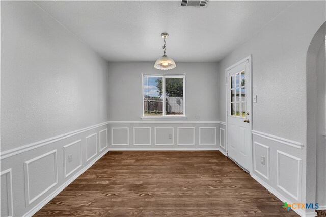 unfurnished dining area with dark hardwood / wood-style floors