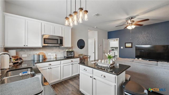 315 Lillianite, New Braunfels, TX 78130 - kitchen featuring stainless steel microwave, a sink, a ceiling fan, decorative backsplash, and open floor plan