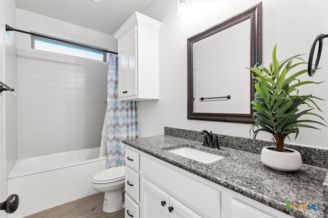 full bathroom with hardwood / wood-style flooring, vanity, toilet, and shower / bath combination with curtain