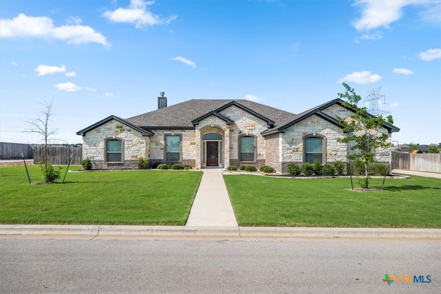 french country home featuring a front yard