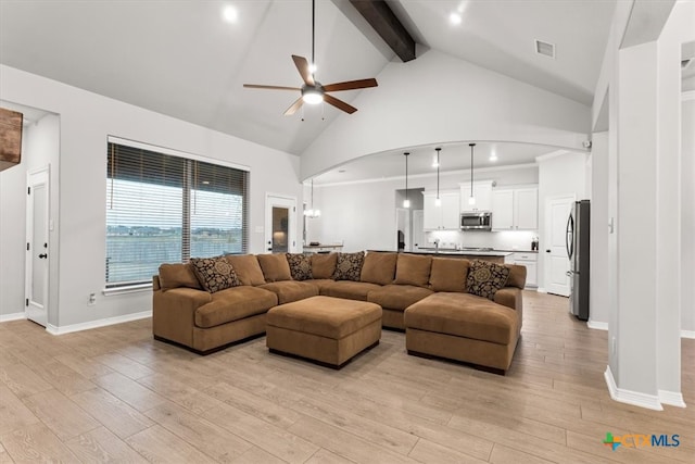 living room featuring ceiling fan, beam ceiling, light hardwood / wood-style flooring, and high vaulted ceiling