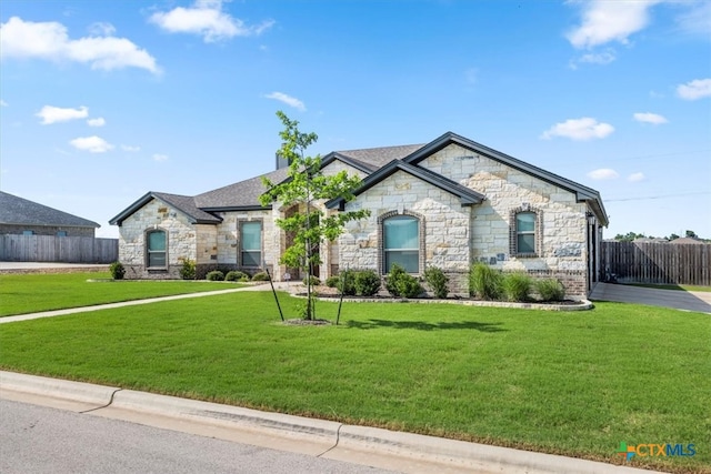 french provincial home with a front yard