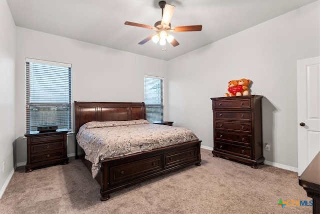 carpeted bedroom with multiple windows and ceiling fan