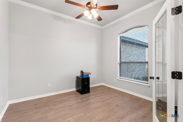 empty room with light wood-type flooring, ceiling fan, and ornamental molding