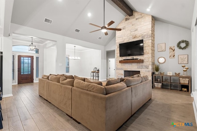 living room with a stone fireplace, high vaulted ceiling, light hardwood / wood-style floors, and beamed ceiling