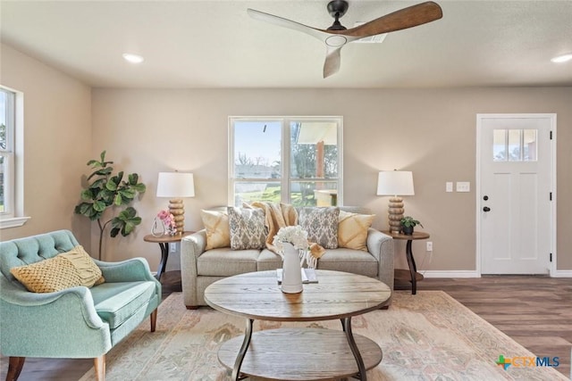 living room with recessed lighting, a ceiling fan, baseboards, and wood finished floors