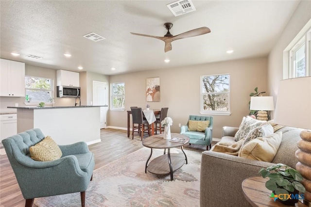 living room featuring visible vents and plenty of natural light