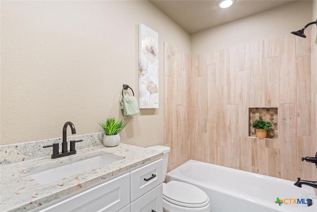 bathroom featuring vanity, toilet, and shower / bathtub combination