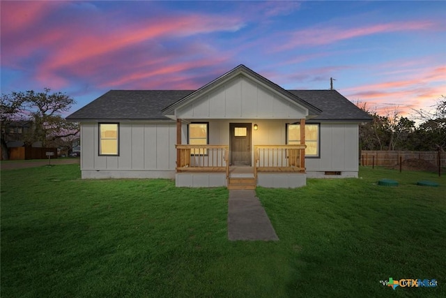 bungalow-style house with crawl space, a yard, a porch, and board and batten siding