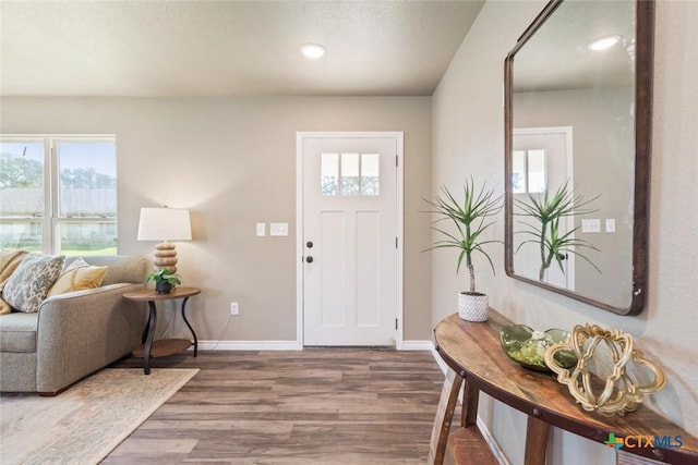 foyer with recessed lighting, wood finished floors, and baseboards