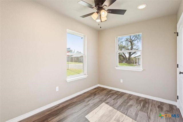 unfurnished room with ceiling fan, baseboards, and wood finished floors