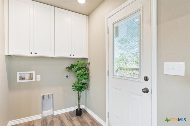 laundry area featuring wood finished floors, cabinet space, baseboards, hookup for an electric dryer, and hookup for a washing machine