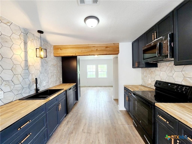 kitchen featuring a sink, wood counters, black appliances, and light wood-style floors