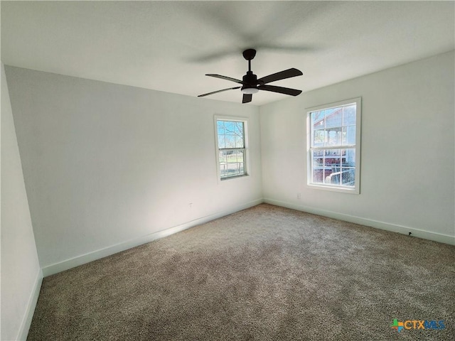 carpeted empty room with baseboards and ceiling fan