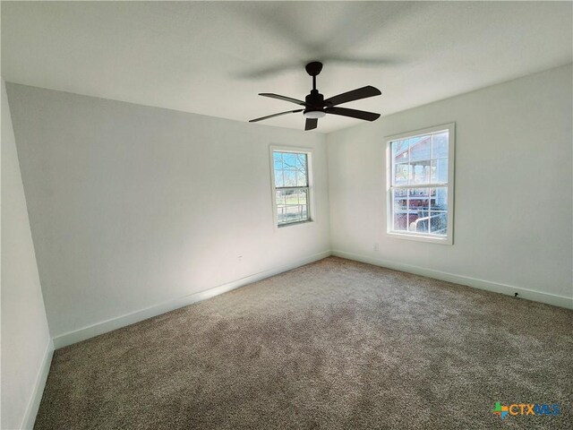 unfurnished room with baseboards, ceiling fan, and carpet floors