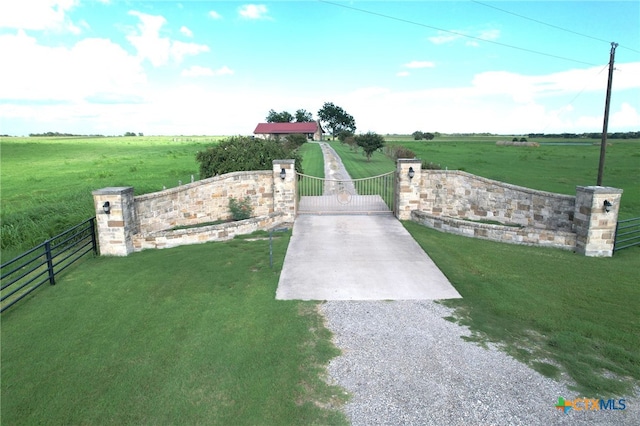 surrounding community featuring a lawn and a rural view