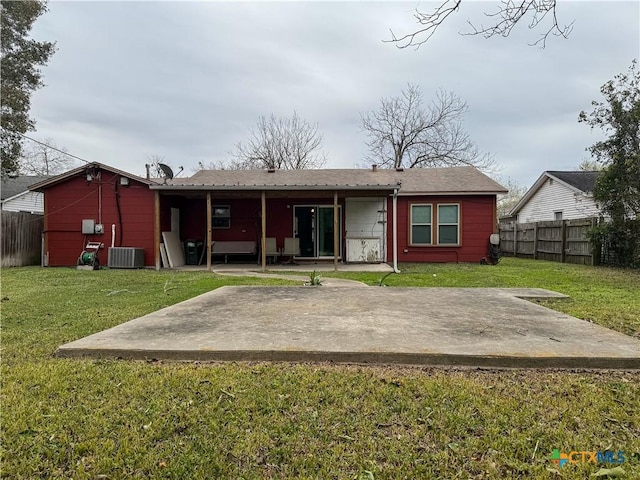 back of property with a yard, a patio, and central AC unit