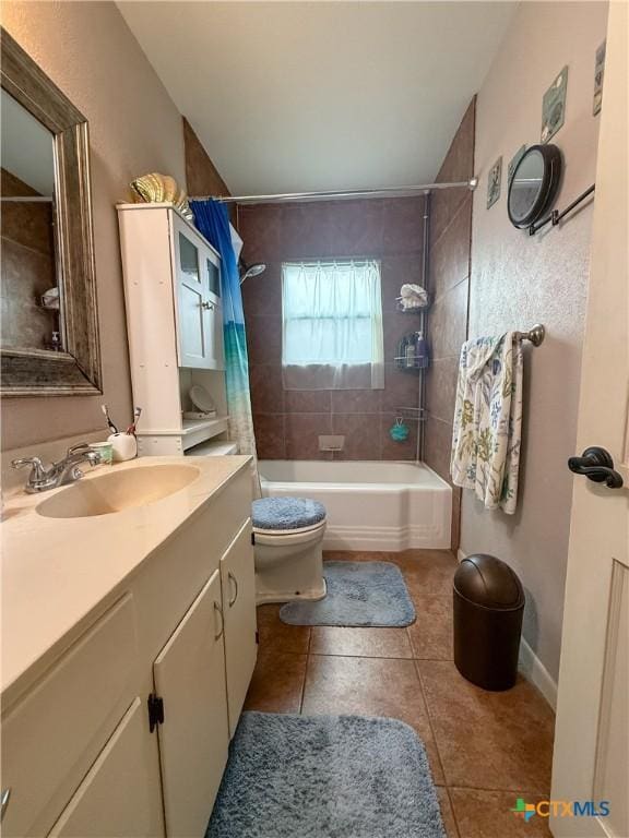 full bathroom featuring tile patterned flooring, vanity, shower / bath combination with curtain, and toilet