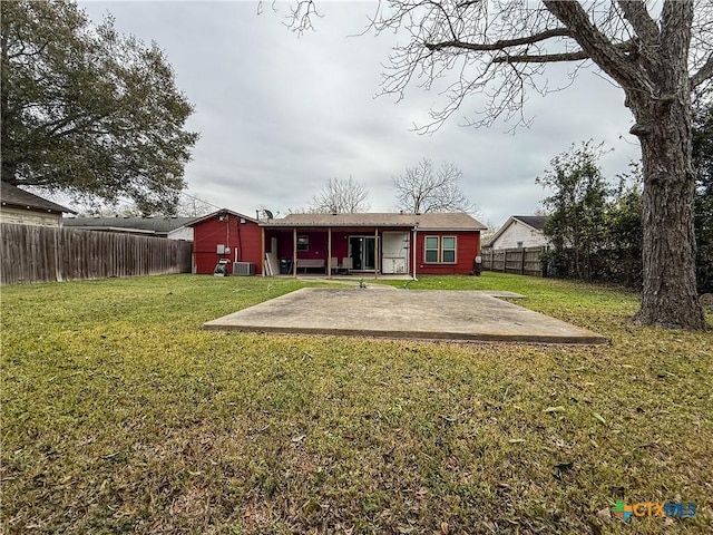 rear view of house featuring a lawn and a patio area