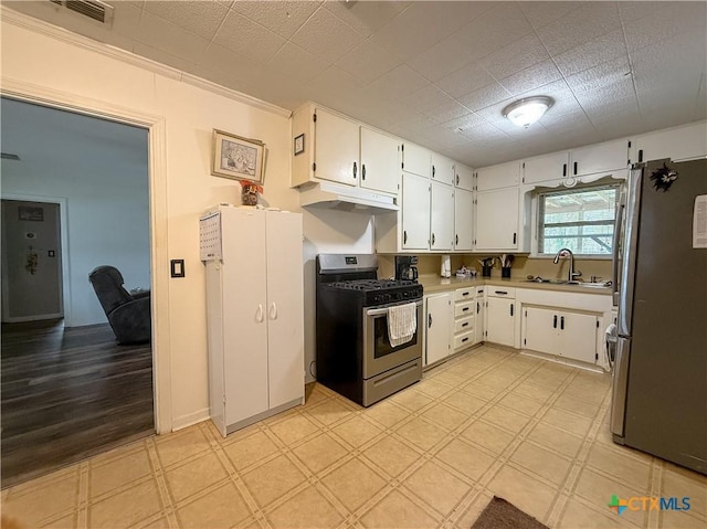 kitchen featuring white cabinets, sink, ornamental molding, and stainless steel appliances