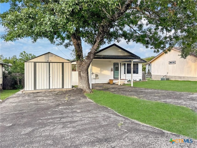 1412 Laurie Dr, Canyon Lake, TX 78133 - view of front of property featuring an outdoor structure and asphalt driveway
