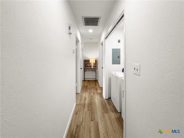 1412 Laurie Dr, Canyon Lake, TX 78133 - hall featuring washer and clothes dryer, wood finished floors, electric panel, baseboards, and a textured wall
