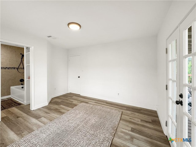 1412 Laurie Dr, Canyon Lake, TX 78133 - unfurnished room with wood finished floors, baseboards, and french doors
